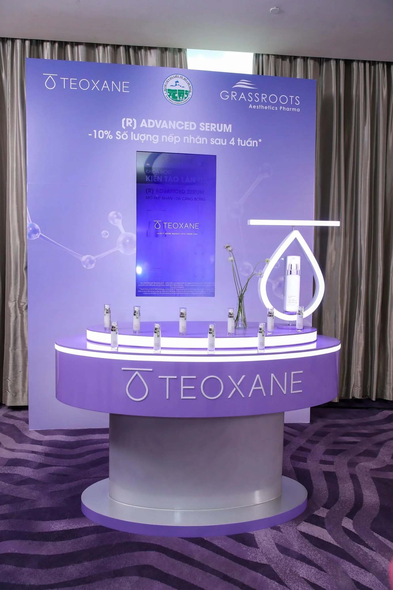 Illuminated lavender (R) Advanced Serum podium with a glowing TEOXANE drop