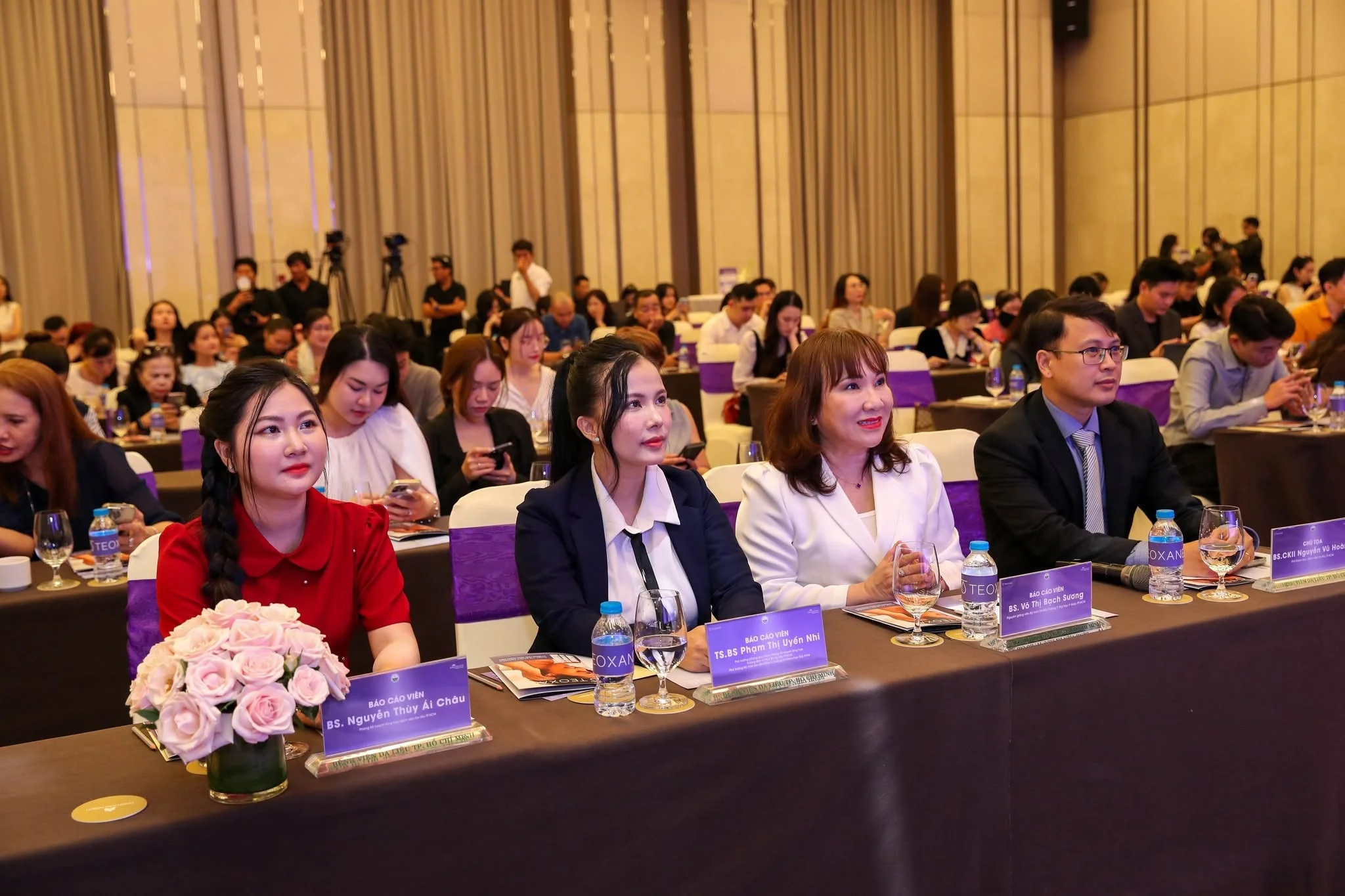 Symposium speakers seated in the front row