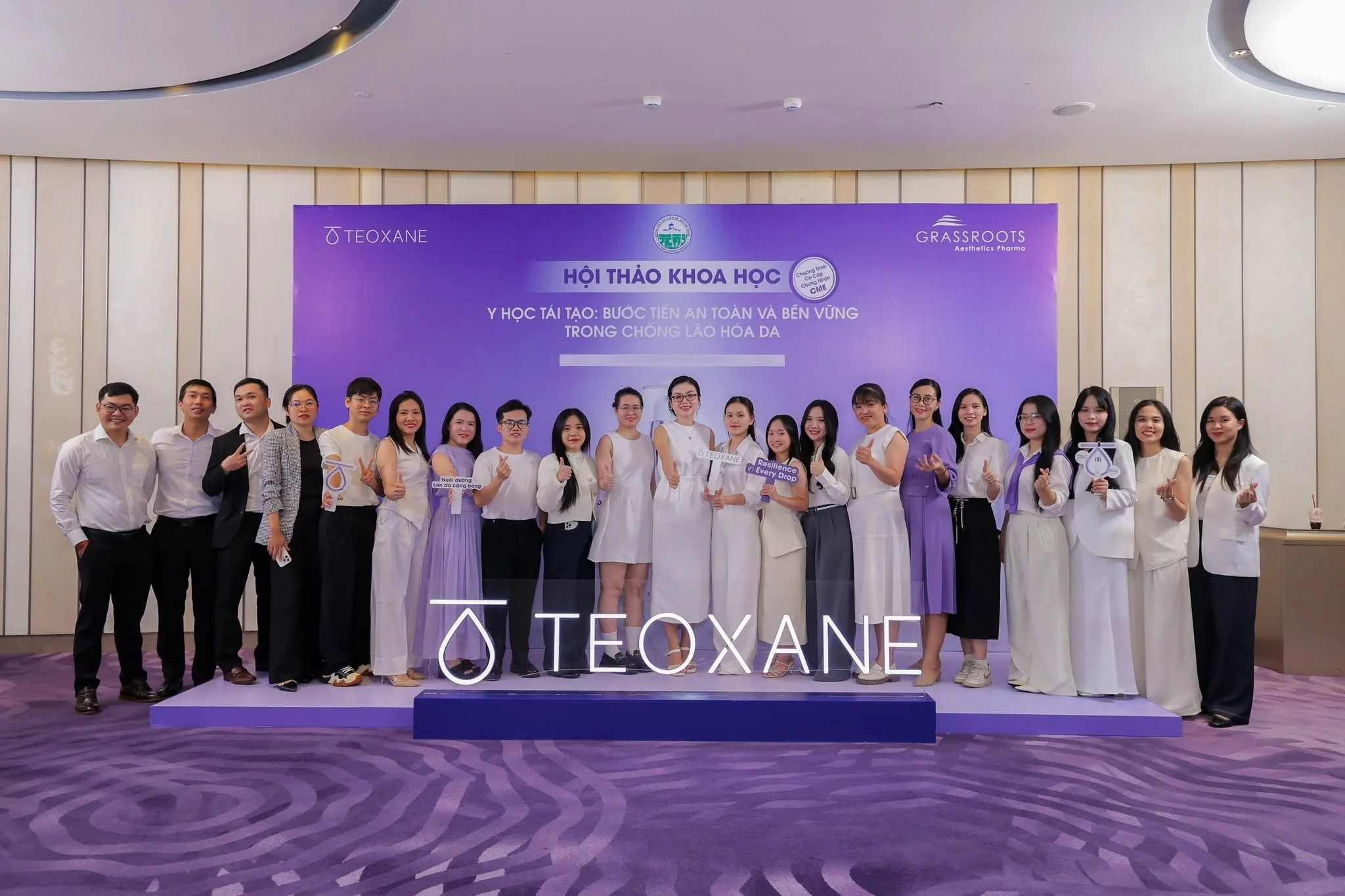 GazeFi and TEOXANE Vietnam teams in front of the symposium backdrop