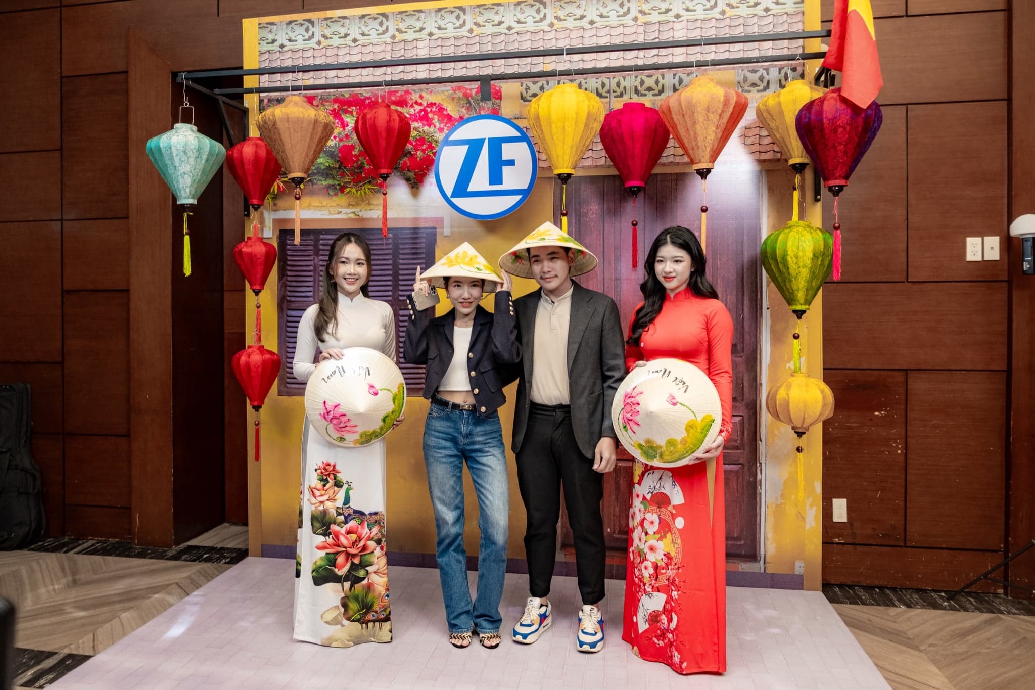 ZF Presentation Slide 04 - Guests in Traditional Vietnamese Dress at Lantern Backdrop